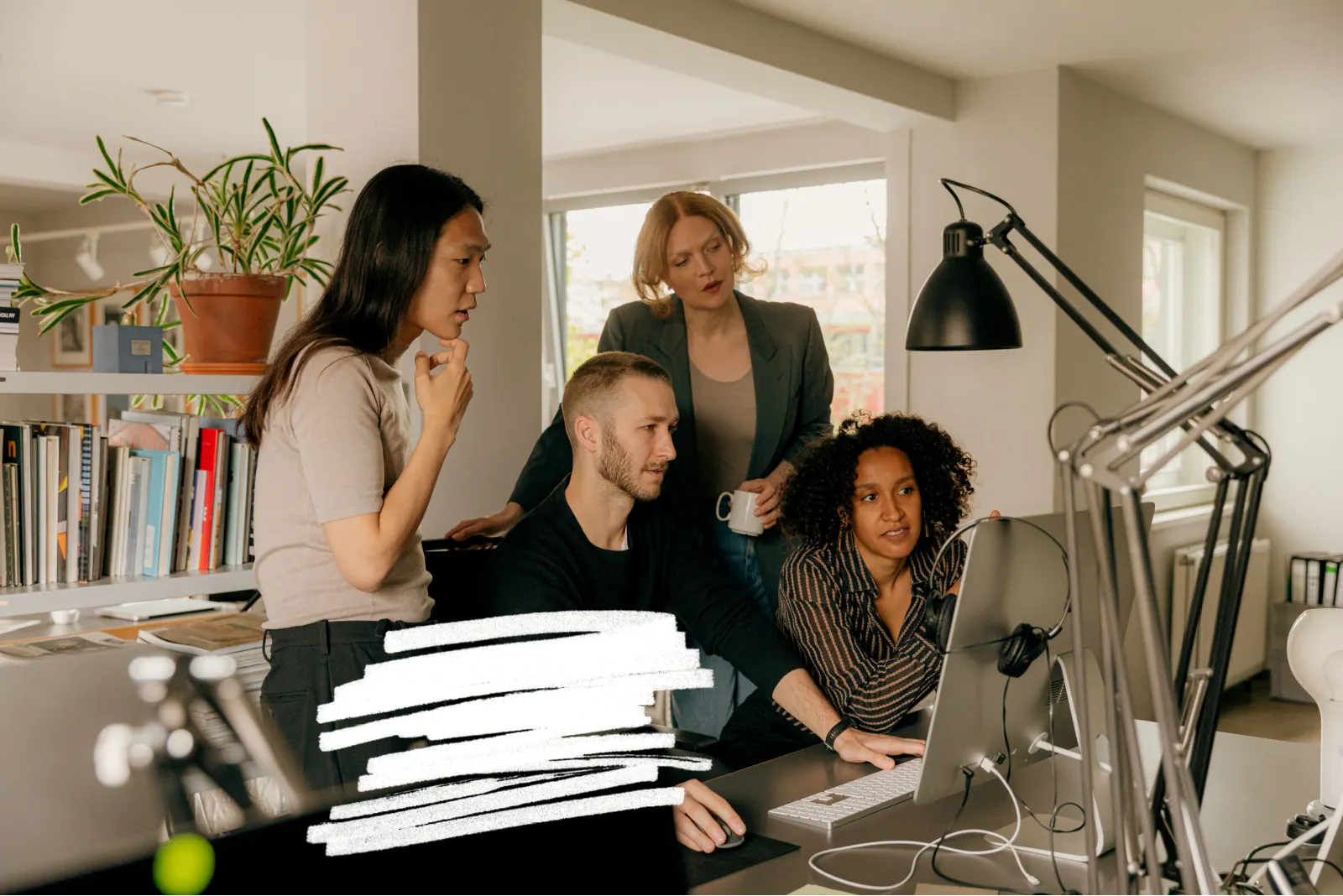 Four people gathered around one screen